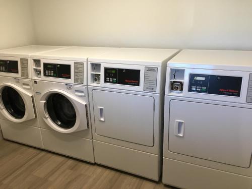 three washing machines are sitting next to each other at Holiday Inn Express & Suites - Rice Lake by IHG in Rice Lake