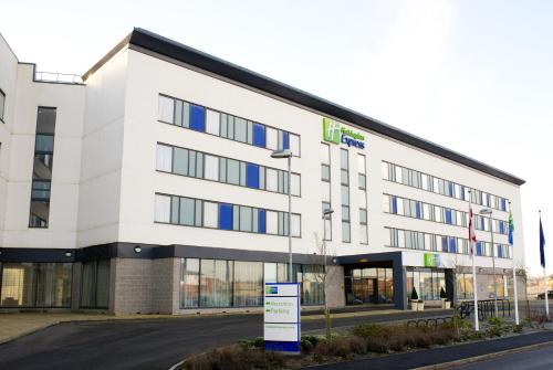 a large white building with a sign in front of it at Holiday Inn Express Rotherham - North by IHG in Rotherham