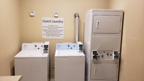 a room with two refrigerators and a sign that says guest laundry at Holiday Inn Express & Suites Galveston West-Seawall in Galveston