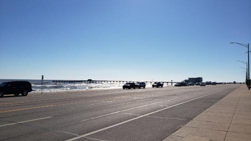 a highway with cars driving on it next to the ocean at Holiday Inn Express & Suites Galveston West-Seawall in Galveston