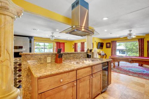 a large kitchen with yellow walls and a sink at Las Vegas Elegance! Pool Table & Sparkling Pool! Home in Las Vegas