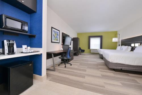 a hotel room with a bed and a desk at Holiday Inn Express Mystic by IHG in Mystic