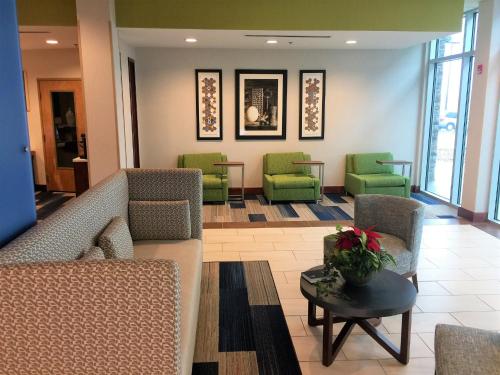 a waiting room with chairs and a couch and a table at Holiday Inn Express & Suites Danville by IHG in Danville