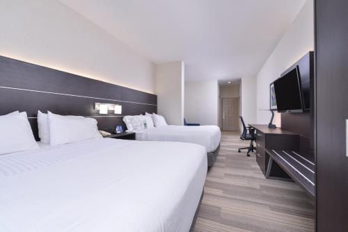 a hotel room with two beds and a flat screen tv at Holiday Inn Express Mystic by IHG in Mystic