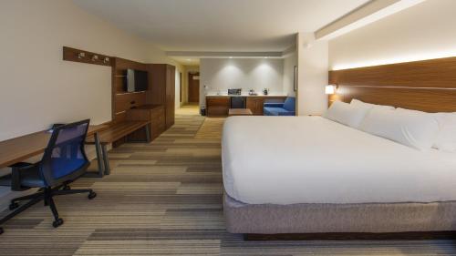 a hotel room with a large bed and a desk at Holiday Inn Express Gatlinburg Downtown by IHG in Gatlinburg