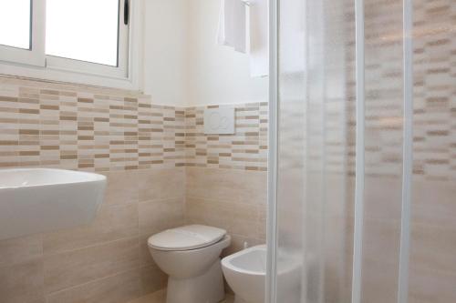 a bathroom with a toilet and a sink and a shower at Hotel Mediterraneo in Civitavecchia