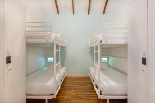 a room with three bunk beds in a room at Nyah - Adult Exclusive in Key West