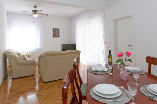 a living room with a table and a dining room at Apartment Angelina in Split