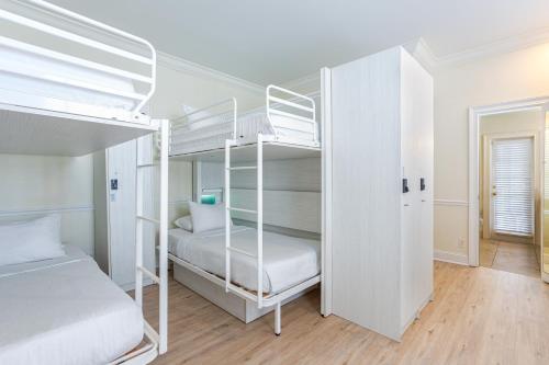 a bedroom with two bunk beds and a hallway at Nyah - Adult Exclusive in Key West