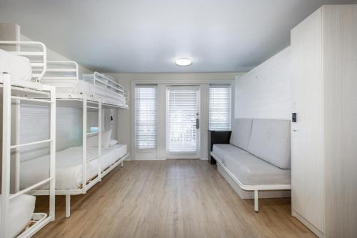 a room with white bunk beds and a window at Nyah - Adult Exclusive in Key West