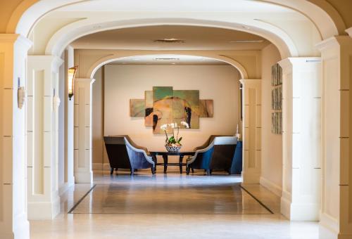 a hallway with a dining room with a table and chairs at One Ocean Resort and Spa in Atlantic Beach