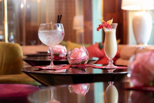 a table with two glasses and a drink on it at Hotel Halm Konstanz in Konstanz
