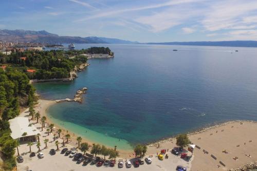 an aerial view of a beach with umbrellas and people at Apartment Angelina in Split