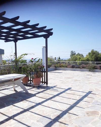 a picnic table and a bench on a patio at Fantastic villa, a 5 minute drive from the beach! in Athens