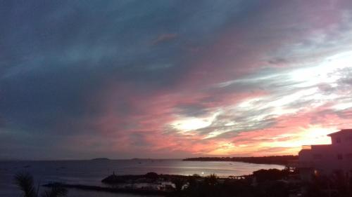 a sunset over a body of water with a cloudy sky at Hotel La Quinta del Sol in Punta Mita