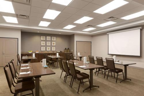 a conference room with tables and chairs and a whiteboard at Country Inn & Suites by Radisson, Bloomington at Mall of America, MN in Bloomington