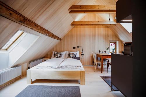 a bedroom with a bed and a dining room at AUGUST Dachgeschosswohnung im jüdischen Viertel in Hohenems