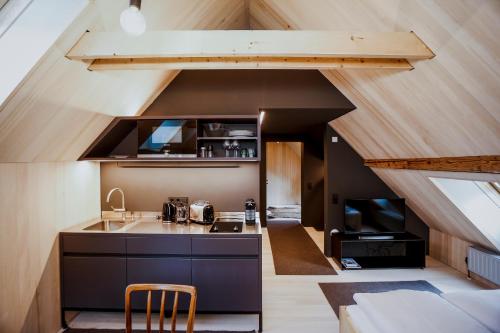 an attic kitchen with a sink and a stove at AUGUST Dachgeschosswohnung im jüdischen Viertel in Hohenems
