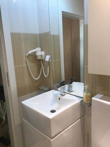 a bathroom with a white sink and a mirror at Iceberg Apartment 50 in Borovets