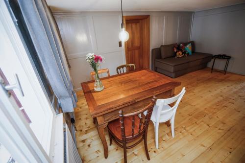 a living room with a wooden table and chairs at MINA Stadtwohnung im Jüdischen Viertel in Hohenems