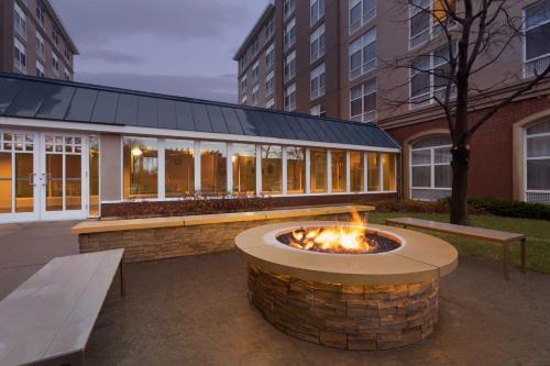 a fire pit in a courtyard in front of a building at Country Inn & Suites by Radisson, Bloomington at Mall of America, MN in Bloomington