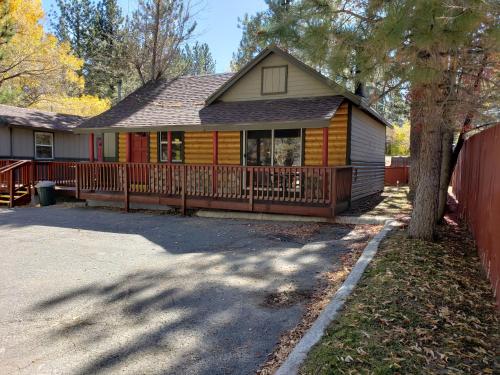 a house with a wooden fence in front of it at Big Bear Frontier in Big Bear Lake