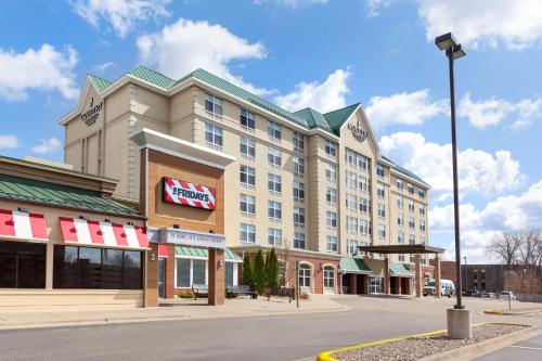 a rendering of a hotel on a city street at Country Inn & Suites by Radisson, Bloomington at Mall of America, MN in Bloomington