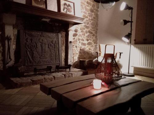 a living room with a table with a vase on it at Maison de gesves in Gesves