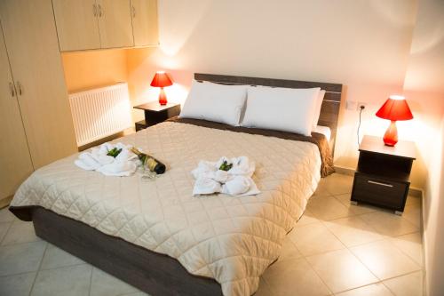 a bedroom with a bed with towels on it at Zante Xigia Bay villas in Khartáta