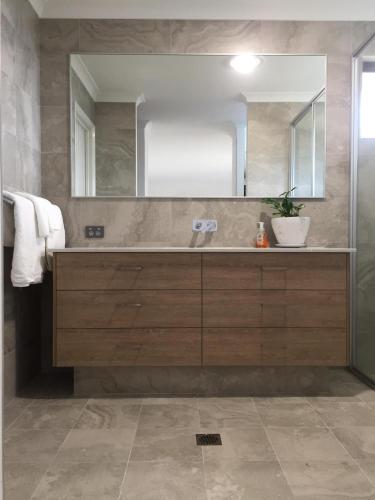 a bathroom with a sink and a mirror at Eagle Bay House in Dunsborough