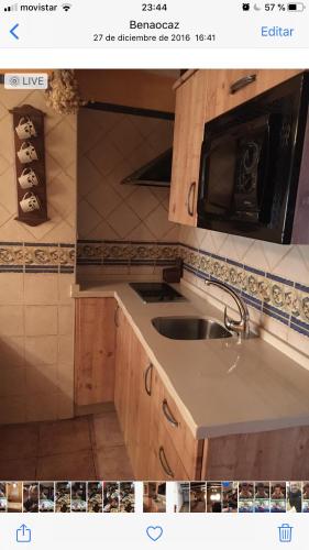 a kitchen with a sink and a microwave at Apartamento Abril in Benaocaz