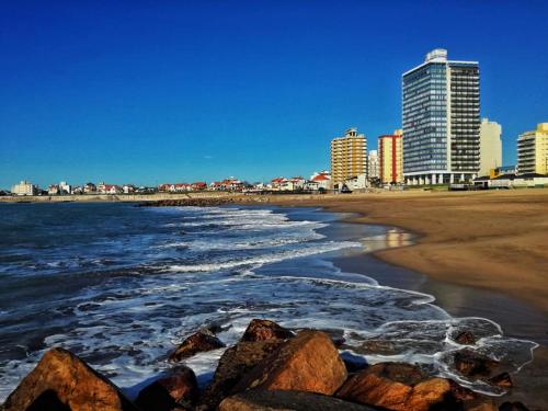 a view of the beach with buildings in the background at Playa Club in Miramar