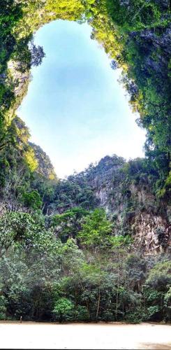 a large opening in the side of a mountain at Cashew Nut Bungalow, Ko Mook in Koh Mook