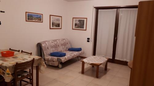 a living room with a couch and a table at Magic Riva Apartment in Riva del Garda
