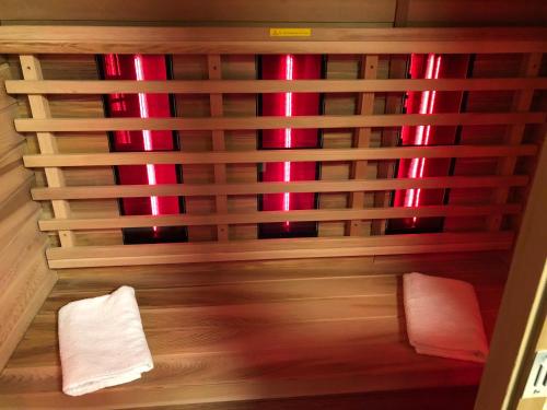 a sauna with two towels and red lights at Vivere in Houthalen-Helchteren