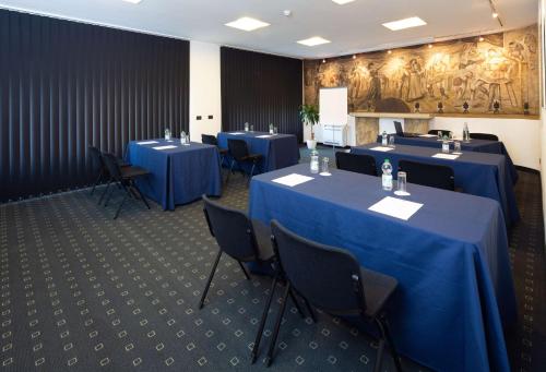 a conference room with blue tables and chairs at Best Western Hotel Biri in Padova