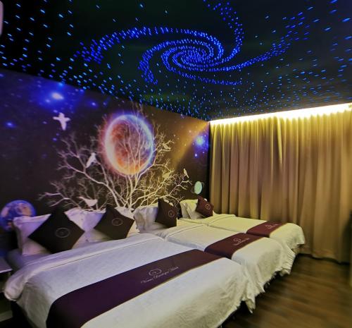 2 camas en una habitación con techo estrellado en Venus Boutique Hotel, en Melaka