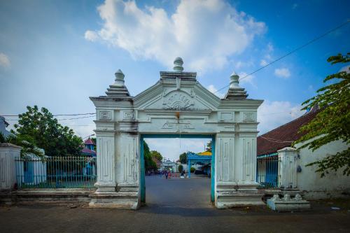 an entrance to a building with a blue door at Monoloog Hotel Solo in Solo