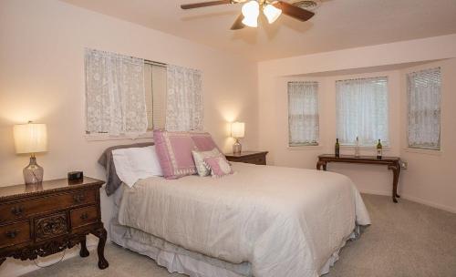 a bedroom with a bed and a ceiling fan at Wine’D Up in Fredericksburg