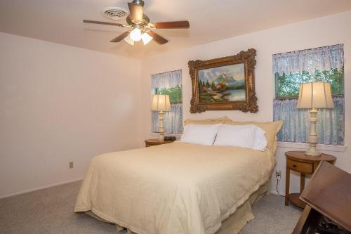 a bedroom with a bed and a ceiling fan at Wine’D Up in Fredericksburg