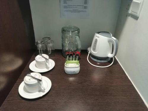 a counter with a coffee maker and a blender at Manja Hotel in Kota Kinabalu