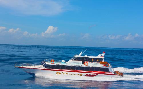 a boat on the water in the ocean at D'Camel Hotel Lembongan in Nusa Lembongan