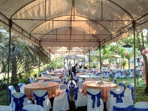 a group of tables and chairs under a tent at Ban Bang Home Resort in Haad Chao Samran