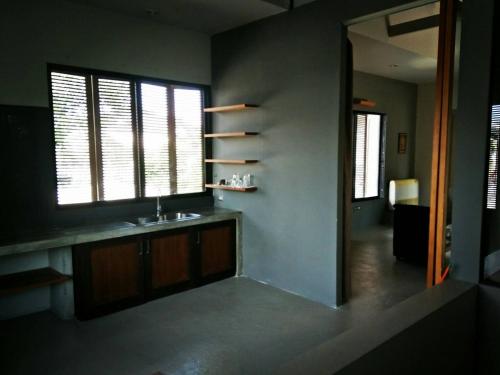 a bathroom with a sink and a mirror at Baba pim villa in Chiang Mai