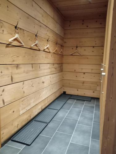 a sauna with wooden walls and a tile floor at Hotel L'Etable in Les Crosets