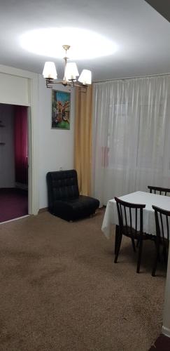 a living room with a table and a couch at Apartment Stefan cel Mare 3 in Bălţi