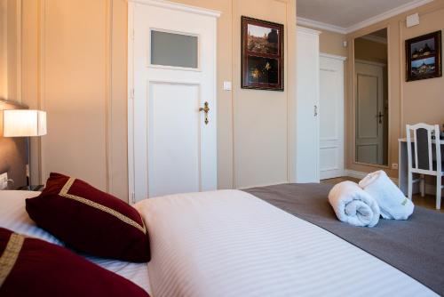 a bedroom with a bed with two towels on it at Willa Krakowska in Raszyn