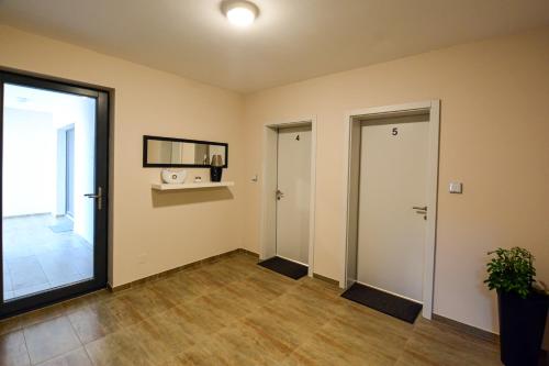 an empty room with a door and a window at Mandarin Premium Apartments in Târgu-Mureş