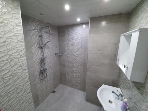a bathroom with a shower and a toilet and a sink at Д и В 2 - D & V 2 Apartment in Sandanski