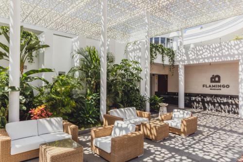 a lobby with white furniture and plants at Flamingo Beach Mate in Adeje